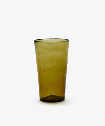 A set of six Elodie Water Glasses, each crafted in the Moroccan style with transparent olive green glass and a slightly irregular surface, is displayed upright on a white background.