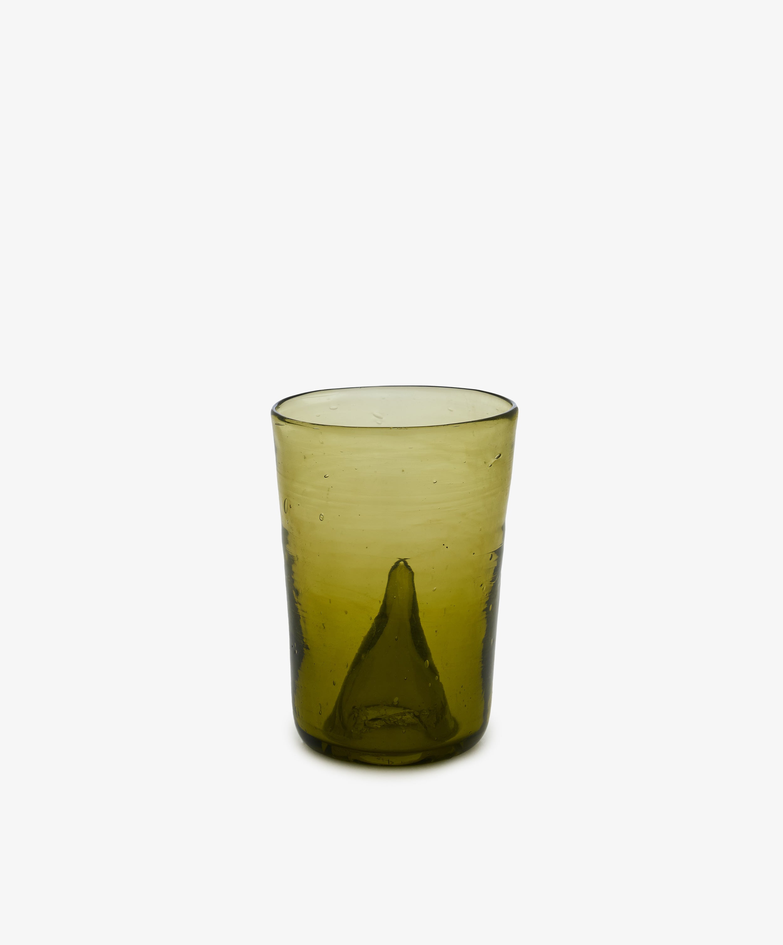A hand-blown Elodie Bedside Carafe and Glass Set tumbler, featuring a subtle green tint and a distinctive raised bump at the center of the base, is showcased against a plain white background—ideal for pairing with your favorite bedside water carafe or nightstand carafe.