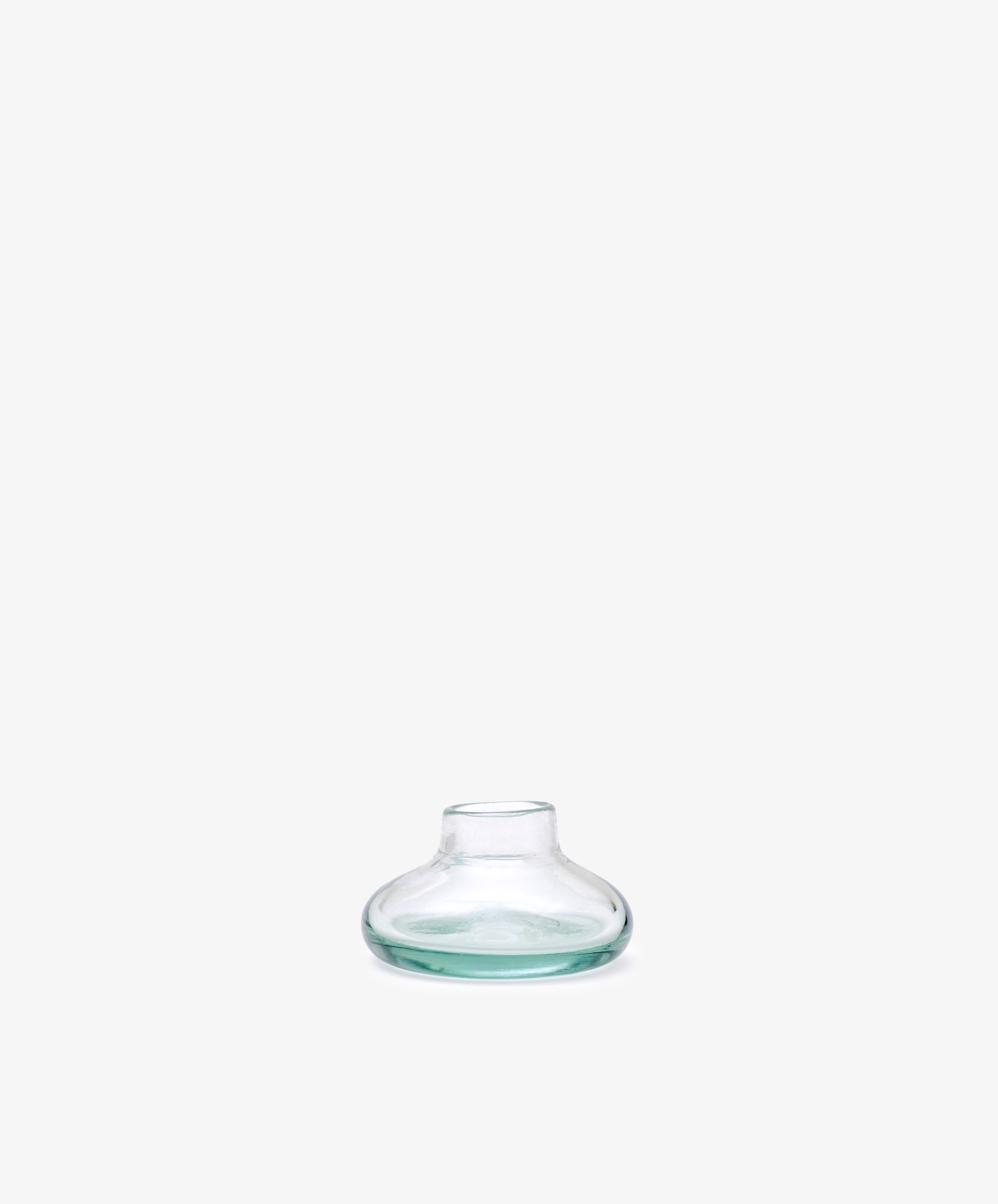 Lucien bubble candleholder, Small—handblown clear glass from Morocco, features a wide, flat base and narrow neck, displayed against a plain white background.