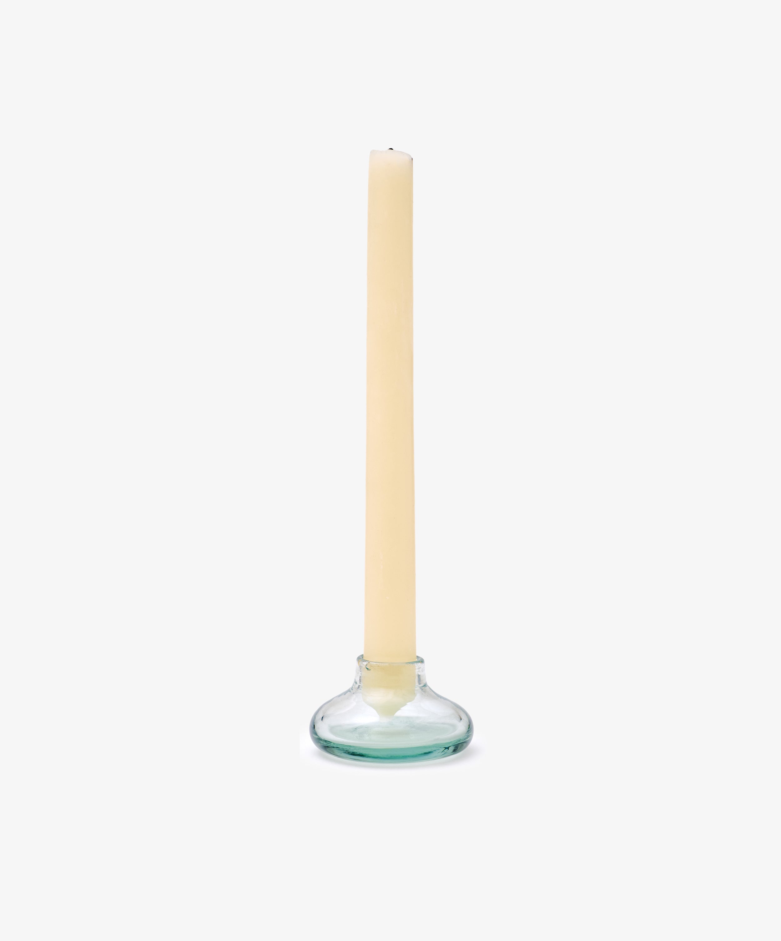 A beige taper candle stands in the Lucien bubble candleholder, Small—handblown in Morocco from recycled glass—set against a plain white background.