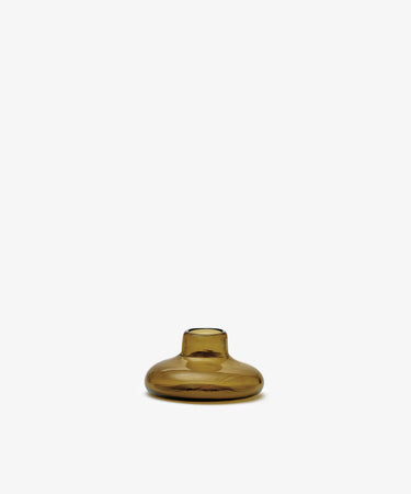 The Lucien bubble candleholder, Small—a handblown, amber-colored glass piece with a narrow opening—stands centered against a plain white background.
