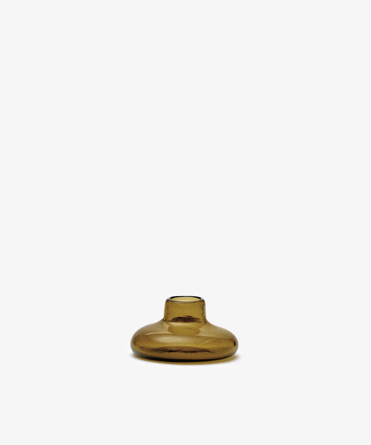 The Lucien bubble candleholder, Small—a handblown, amber-colored glass piece with a narrow opening—stands centered against a plain white background.