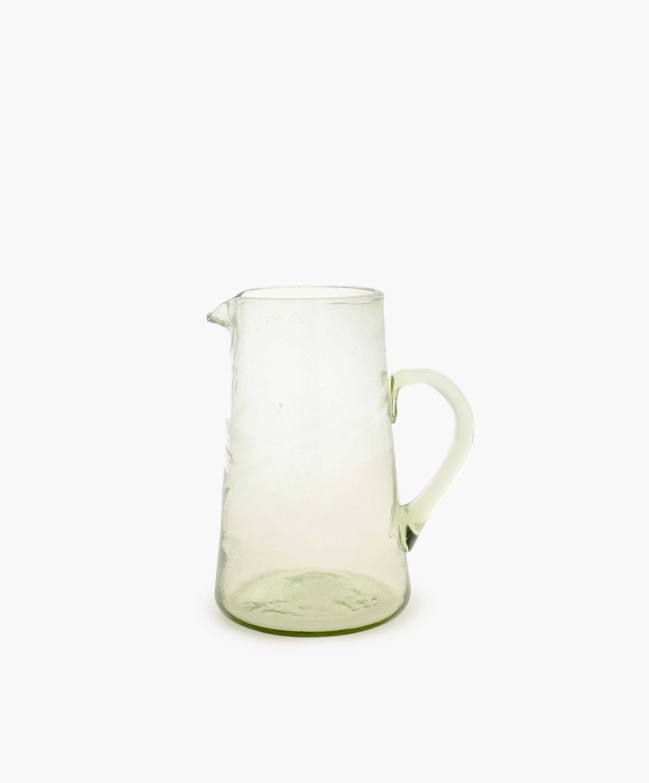 The Elodie Pitcher is a handblown Damascus glass piece with a handle and small spout, ideal for adding Mediterranean charm to your decor. Shown against a plain white background.