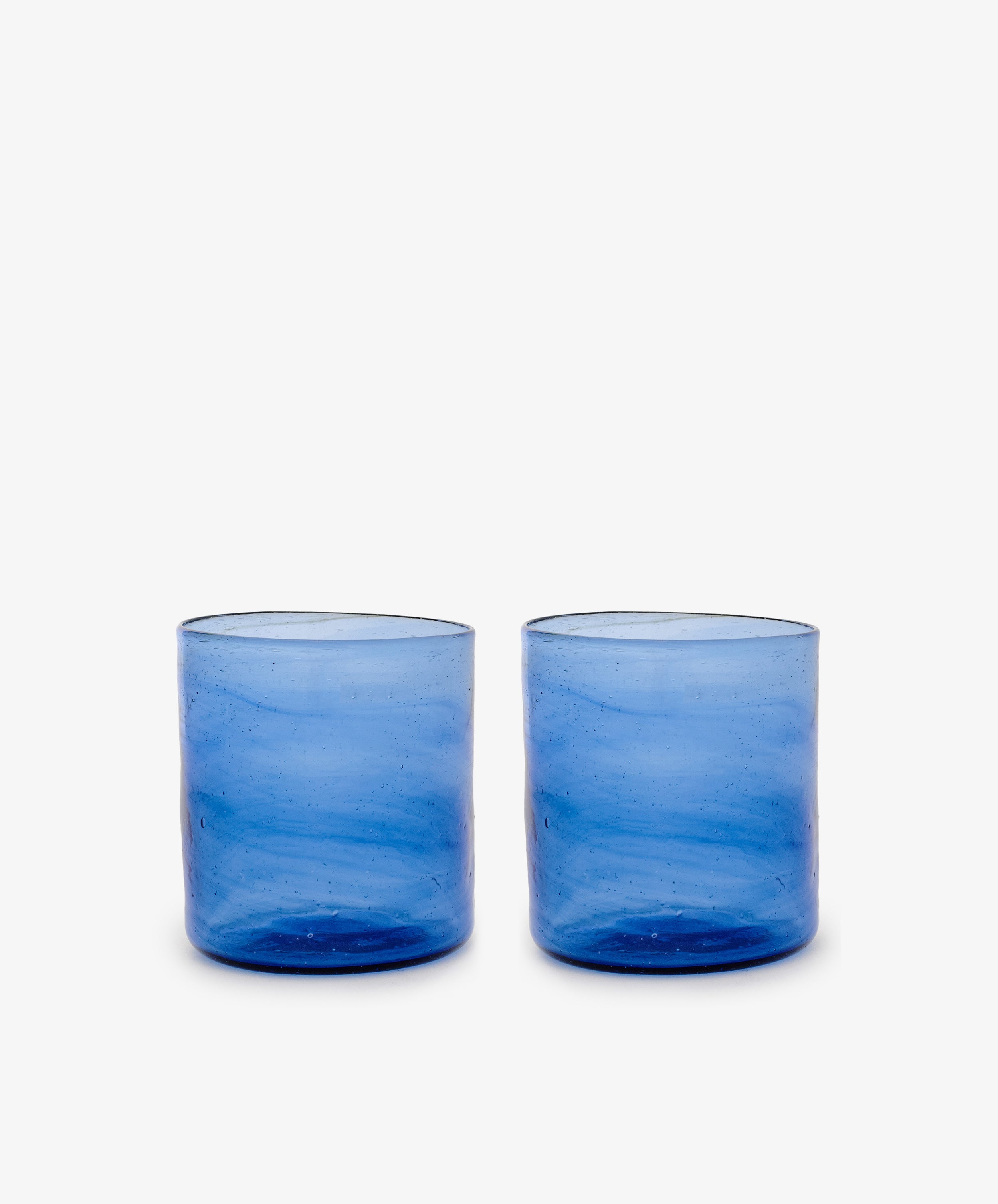 Six Elodie Straight Glasses, crafted from recycled blue glass with a subtle texture, are arranged side by side on a plain white background.