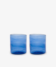 Six Elodie Straight Glasses, crafted from recycled blue glass with a subtle texture, are arranged side by side on a plain white background.