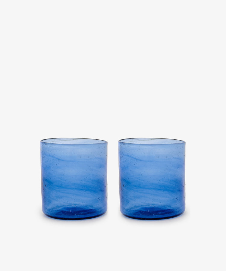 Six Elodie Straight Glasses, crafted from recycled blue glass with a subtle texture, are arranged side by side on a plain white background.