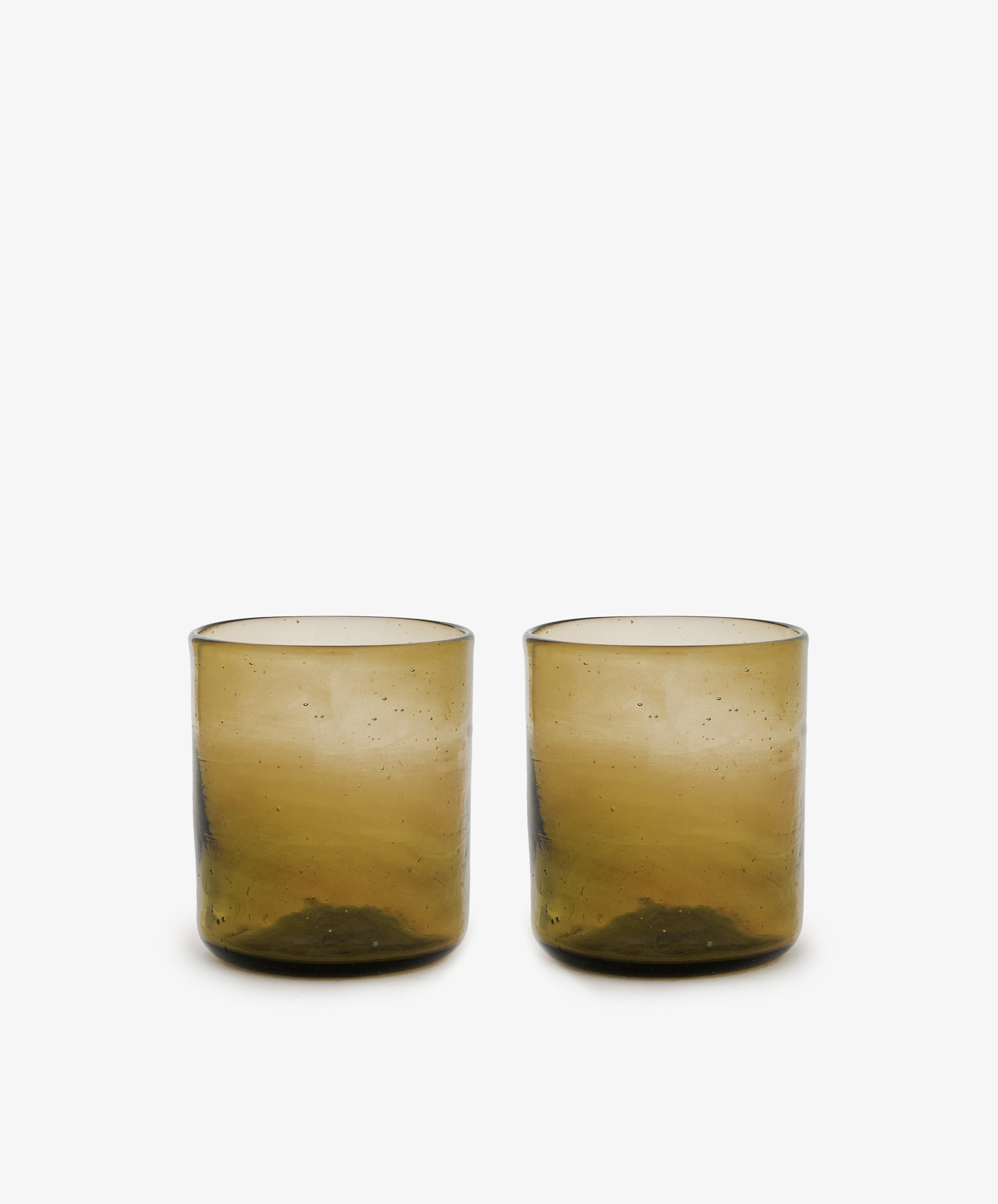 Six Elodie Straight Glass tumblers, handblown from recycled glass with a slightly textured brown surface, are displayed side by side on a plain white background.