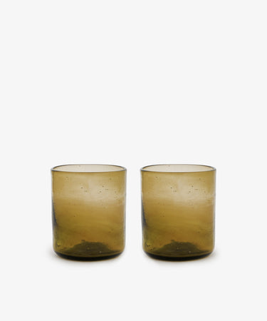 Six Elodie Straight Glass tumblers, handblown from recycled glass with a slightly textured brown surface, are displayed side by side on a plain white background.