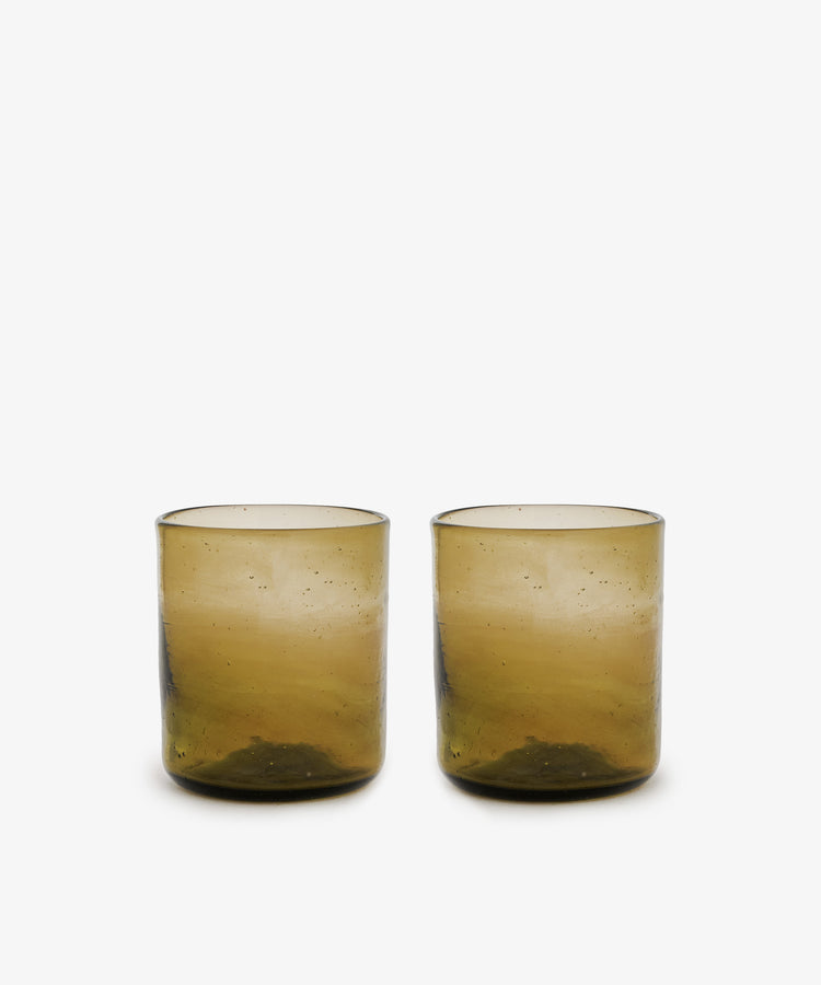 Six Elodie Straight Glass tumblers, handblown from recycled glass with a slightly textured brown surface, are displayed side by side on a plain white background.