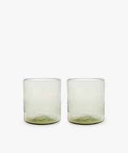 A set of six Elodie Straight Glasses, made from recycled glass with subtly green-tinted bases, are arranged side by side on a plain white background.