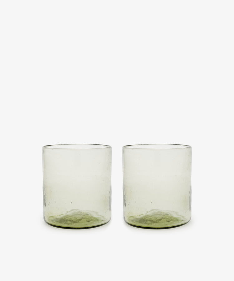 A set of six Elodie Straight Glasses, made from recycled glass with subtly green-tinted bases, are arranged side by side on a plain white background.