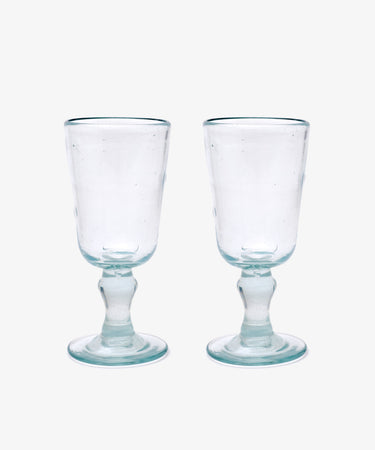 The Elodie Stemmed Wine Glass, Set of 6 features clear handmade glasses with short stems and round bases, shown side by side on a plain white background.