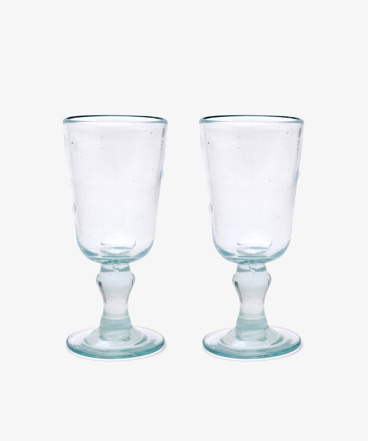 The Elodie Stemmed Wine Glass, Set of 6 features clear handmade glasses with short stems and round bases, shown side by side on a plain white background.