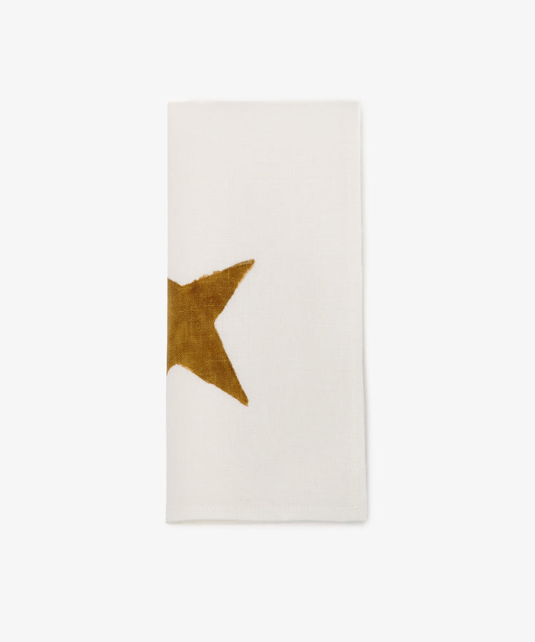 The Nova Napkin, Set of 6, features ivory linen hand block-printed with the left side of a gold star on the edge, shown here against a plain white background.