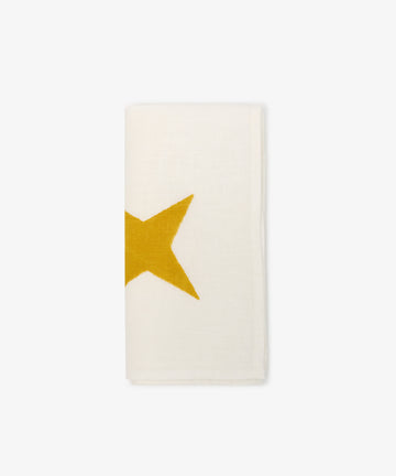 The Nova Napkin, Set of 6, features folded white ivory linen with a hand block-printed yellow star design on the left side, displayed against a plain white background.