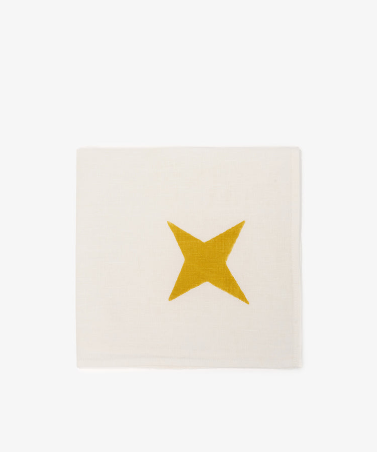 The Nova Napkin, Set of 6, features ivory linen hand block-printed with a single yellow star in the center, shown on a plain white background.
