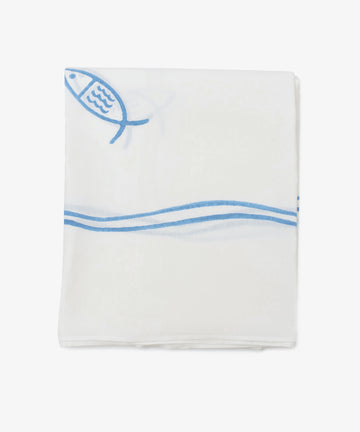 The Pezza Tablecloth is a handmade white cloth, neatly folded with a simple blue fish and wave design on one corner—perfect for adding charm and elegance to any setting.