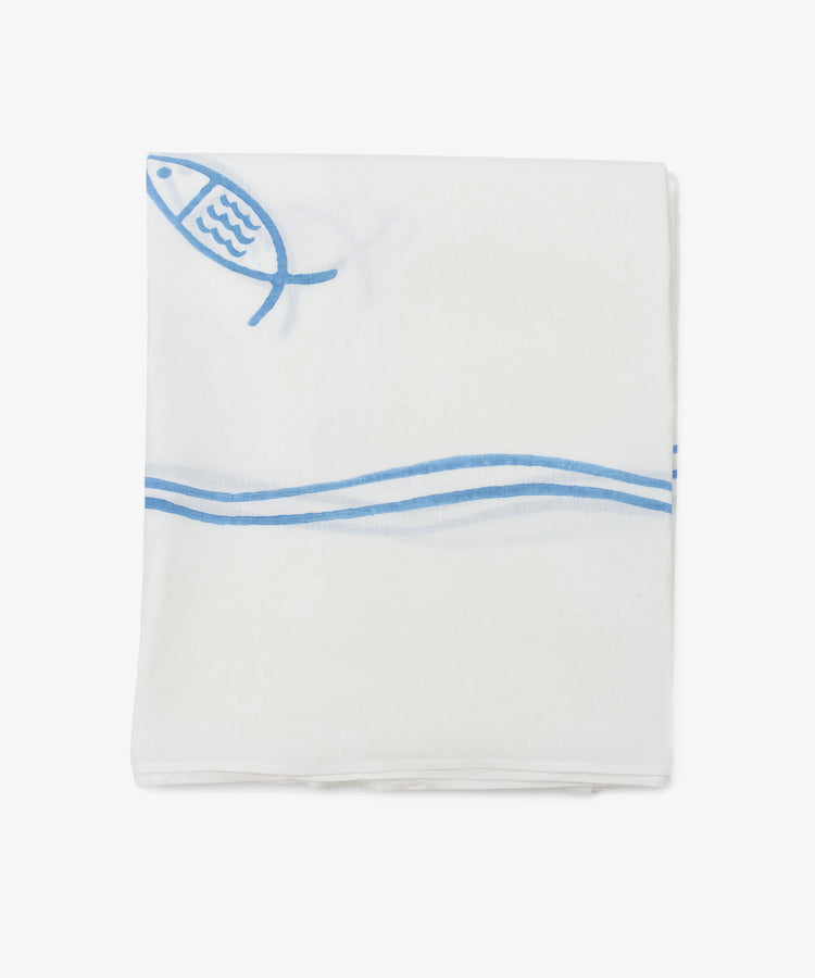 The Pezza Tablecloth is a handmade white cloth, neatly folded with a simple blue fish and wave design on one corner—perfect for adding charm and elegance to any setting.
