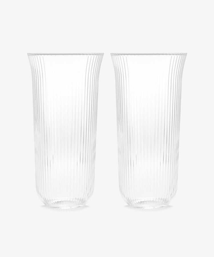 The Linea Ribbed Water Glass, Set of 4, features clear, tall glasses with vertical texture for an elegant look, perfect for any setting.