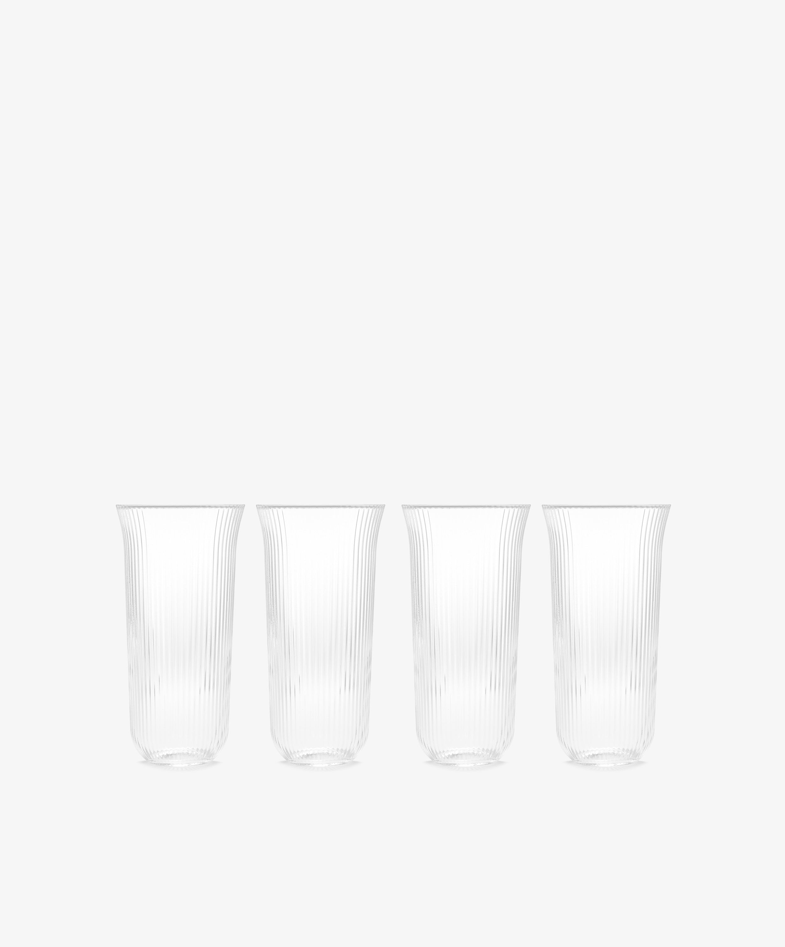 The Linea Ribbed Water Glass, Set of 4, features elegant ribbed glasses arranged on a white background, capturing the relaxed charm of coastal bistro style.