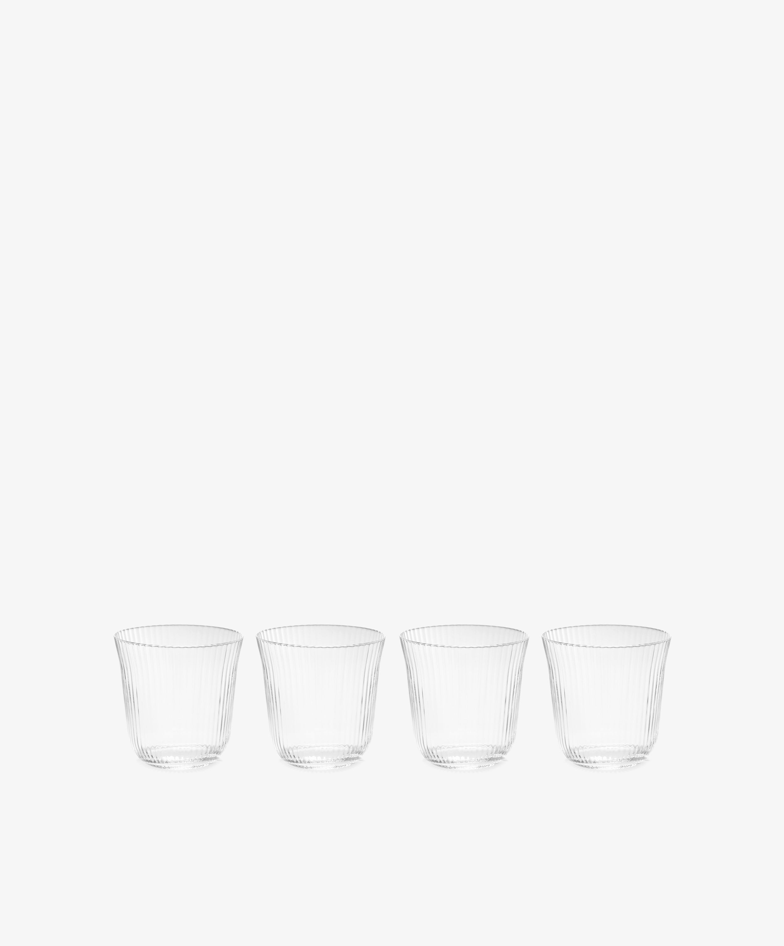 The Linea Ribbed Tumbler, Set of 4, features tapered ribbed glasses arranged in a row on a white background—ideal for any restaurant glassware collection.