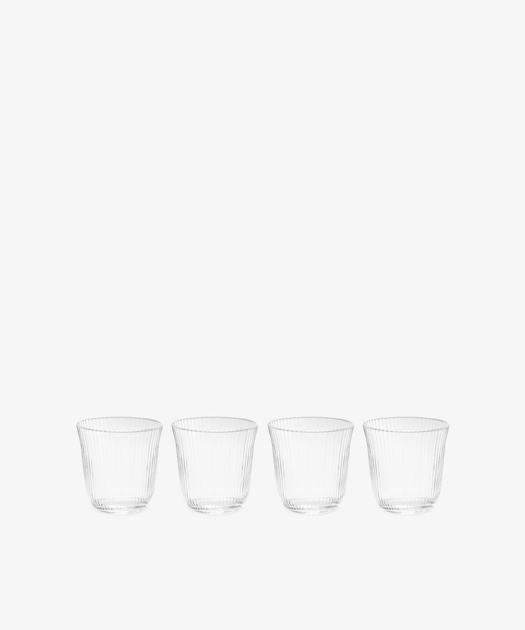 The Linea Ribbed Tumbler, Set of 4, features tapered ribbed glasses arranged in a row on a white background—ideal for any restaurant glassware collection.