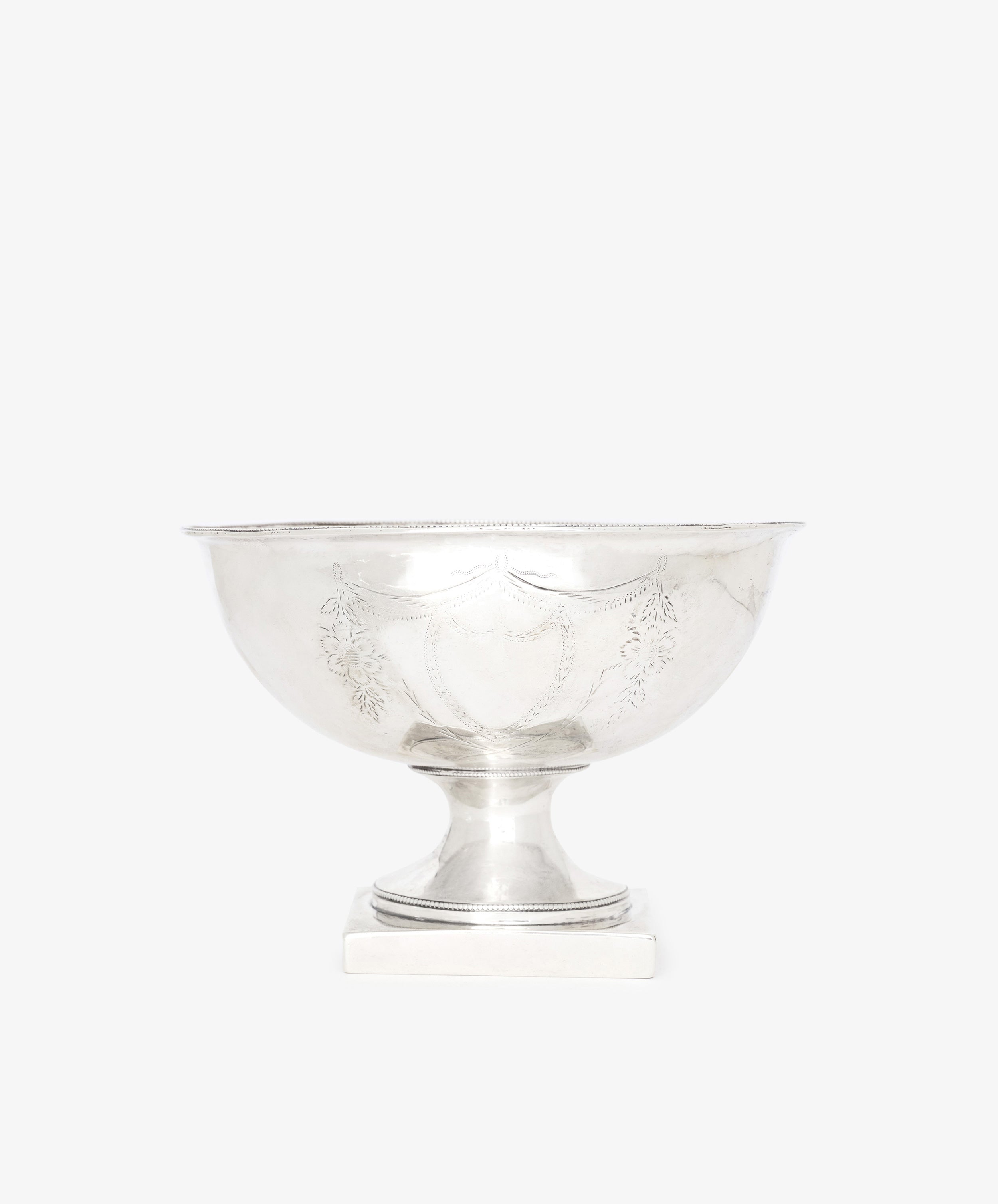 The Vintage Silver Bowl features engraved decorative patterns on its sides and a pedestal base, shown against a plain white background.
