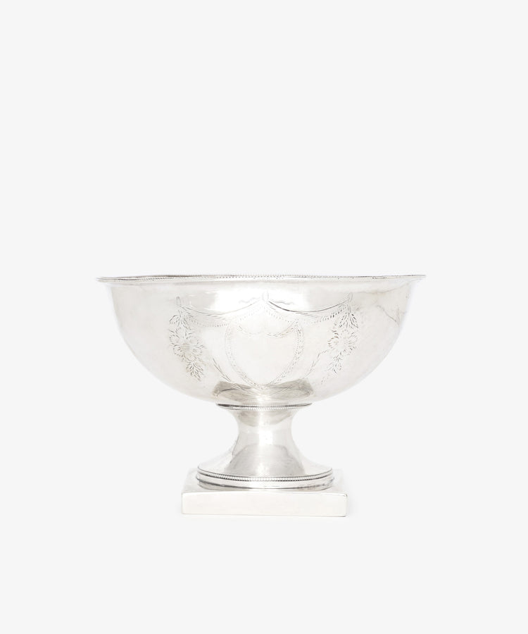 The Vintage Silver Bowl features engraved decorative patterns on its sides and a pedestal base, shown against a plain white background.
