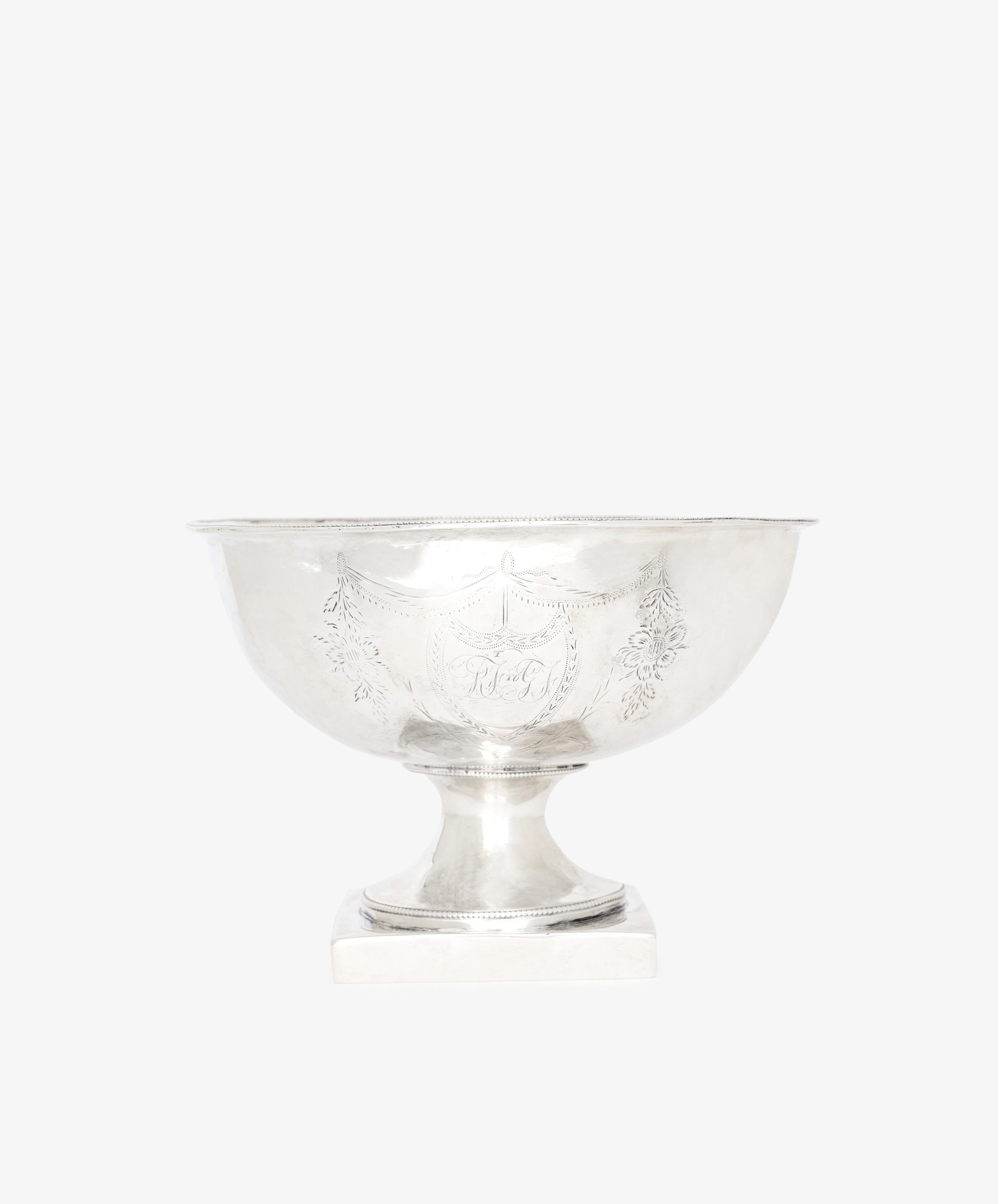 The Vintage Silver Bowl, featuring engraved decorative patterns and a square base, is elegantly displayed against a plain white background.
