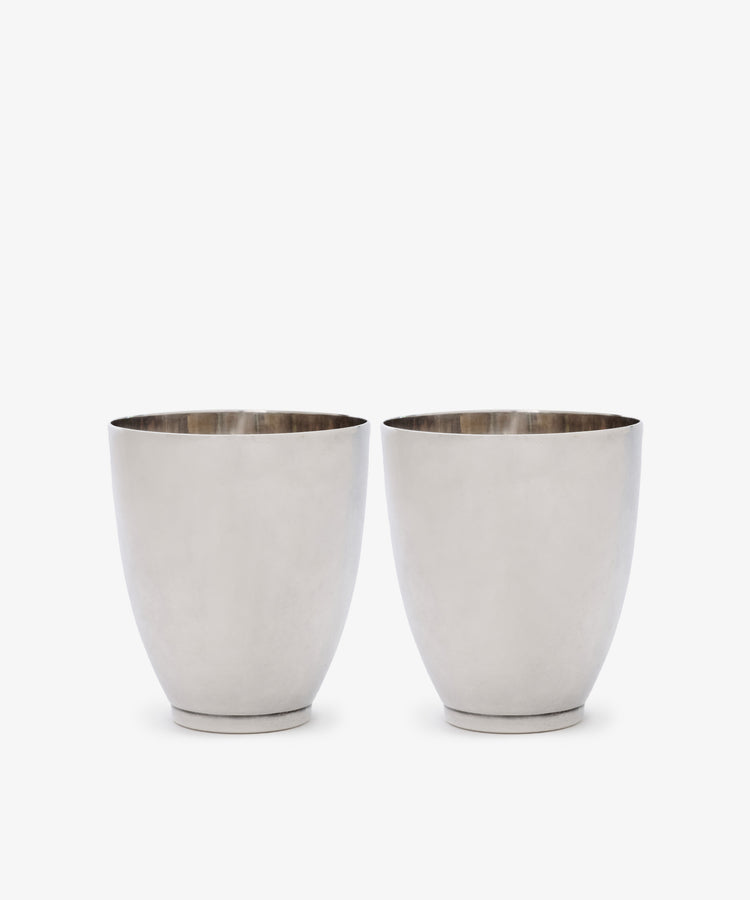 A Vintage Pair of Silver Beakers is displayed side by side on a white background, their minimalist design evoking the timeless elegance of Sheffield 2004.