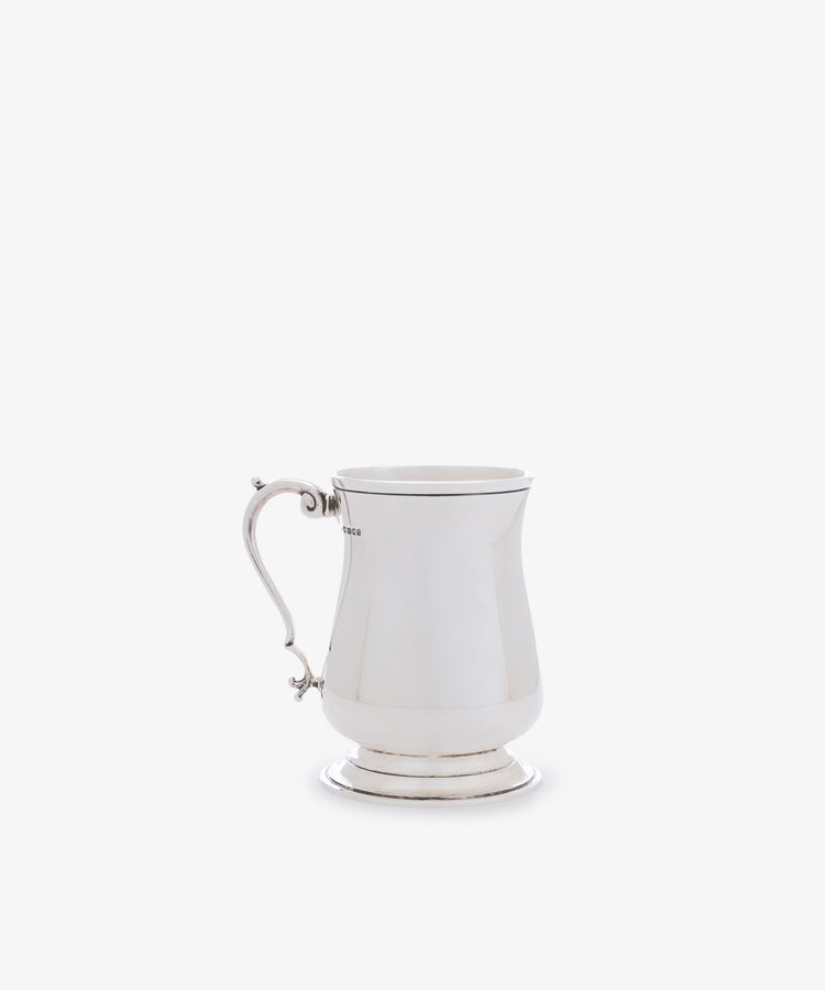 A Vintage English Silver Child's Mug featuring a curved handle and flared base is displayed against a white background—an elegant and timeless gift for babies.