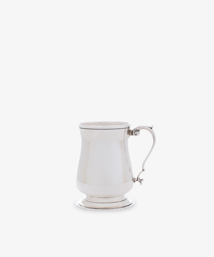 The Vintage English Silver Child's Mug features a polished finish, curved handle, flared base, and gently tapered body, shown against a plain white background.