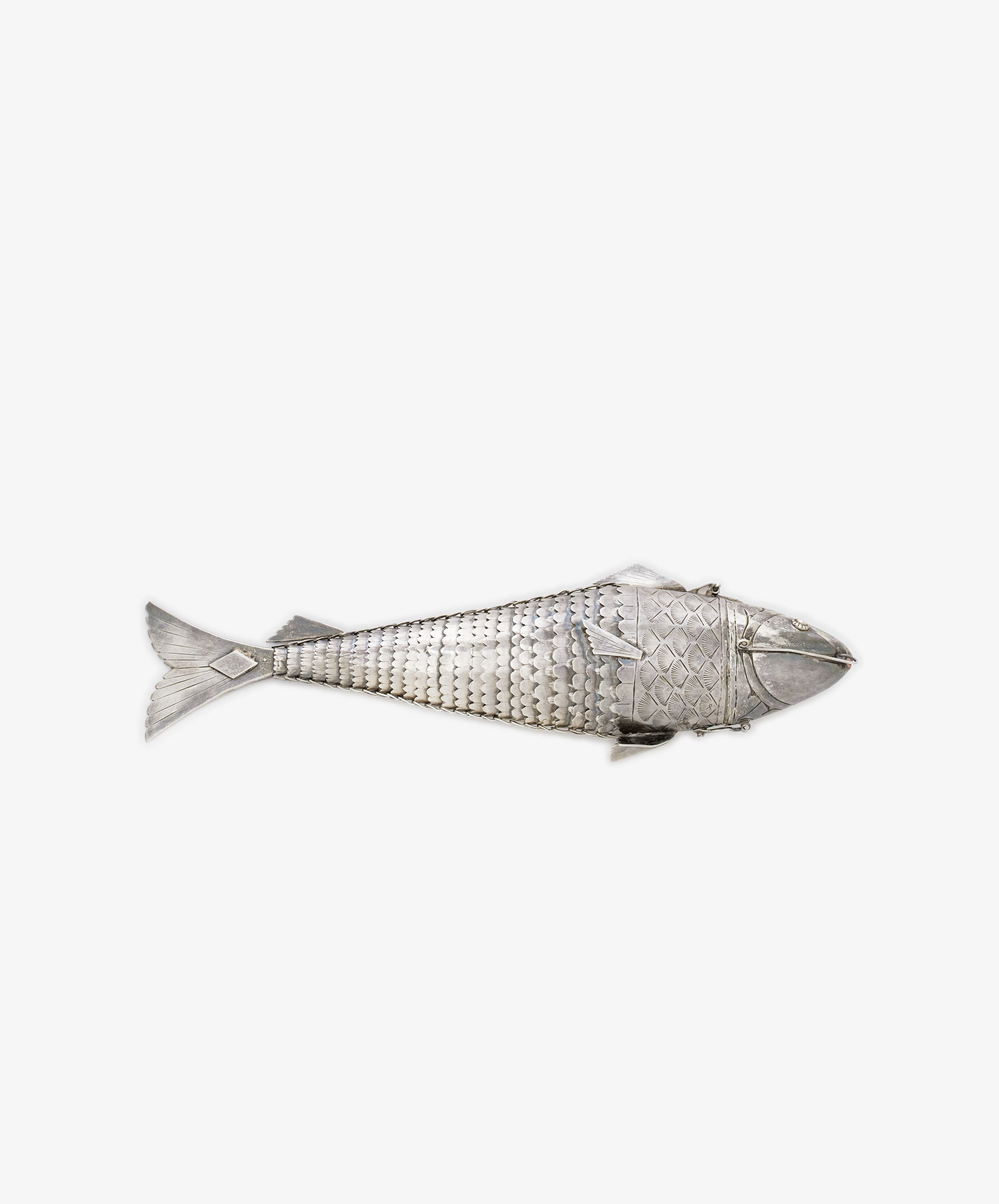 A Vintage Silver Articulating Fish, featuring textured scales and intricate details, is displayed on a plain white background.