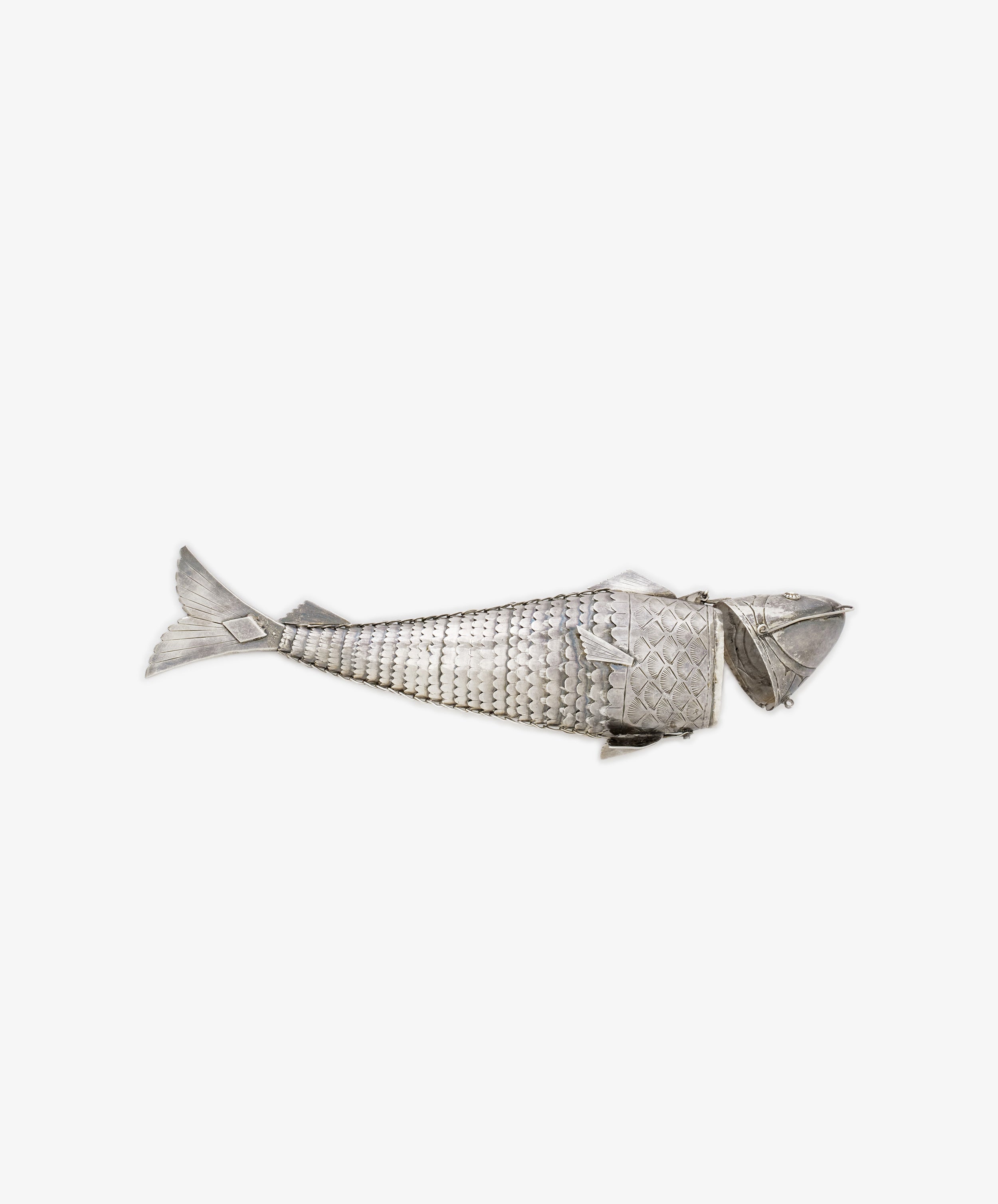 The Vintage Silver Articulating Fish, featuring a segmented body, textured scales, and movable fins, is displayed on a plain white background and evokes the charm of a lucky talisman.