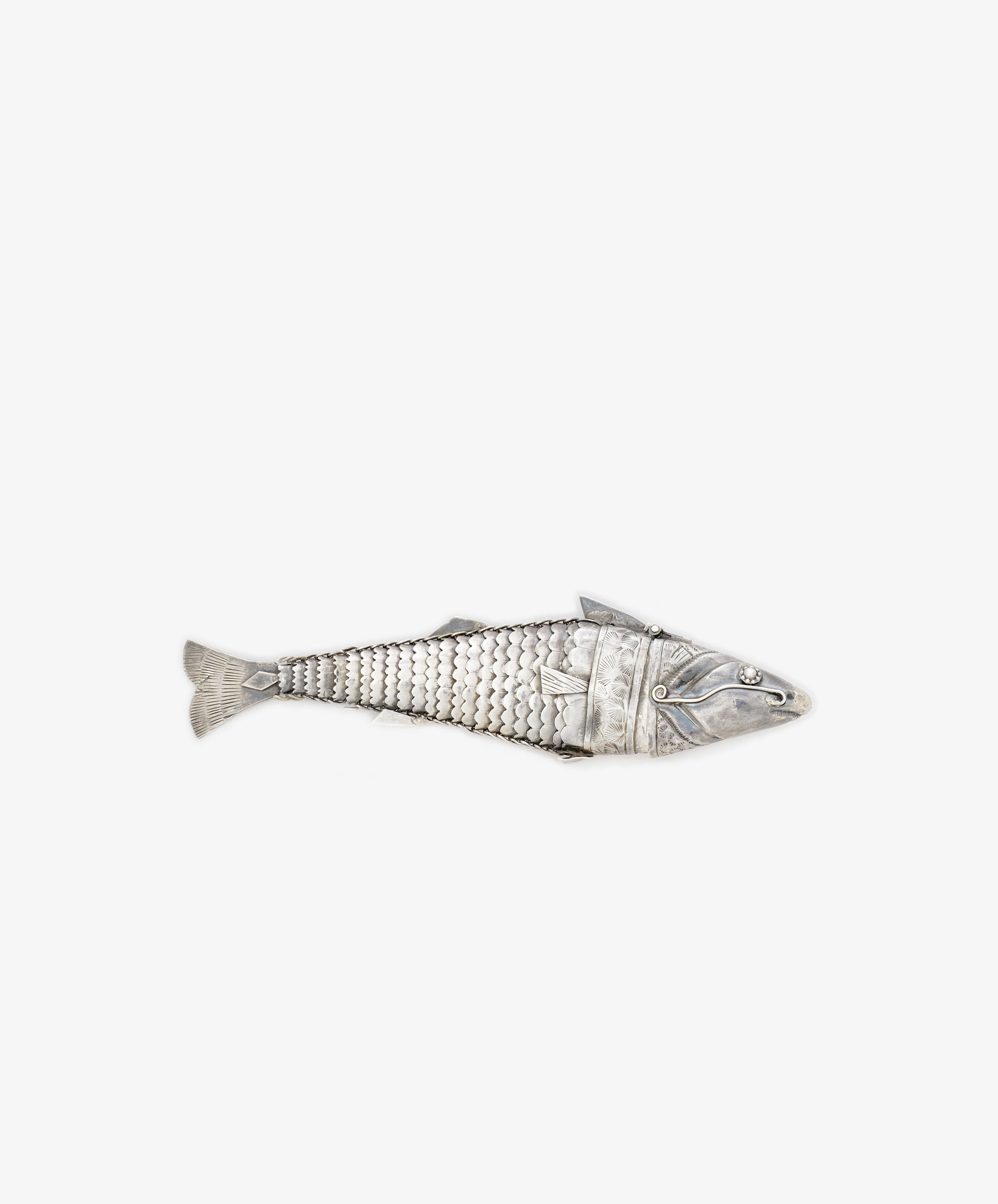 The Vintage Silver Articulating Fish charm features detailed scales and movable segments, resembling a lucky talisman, beautifully displayed on a plain white background.