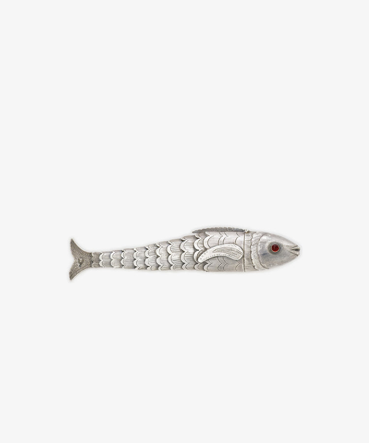 The Vintage Silver Articulating Fish features engraved scales, a red eye, and articulated segments. Shown from the side against a plain white background, this charm is often regarded as a lucky talisman.