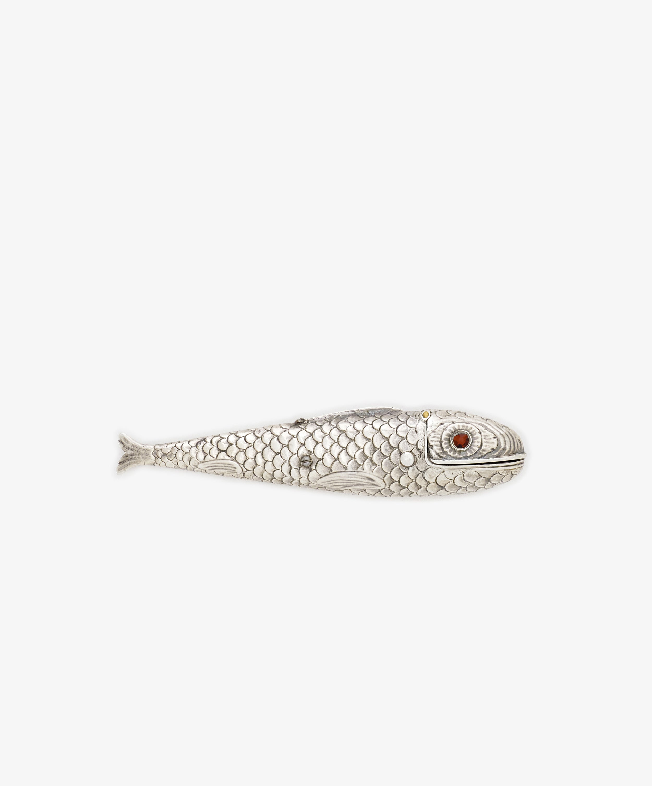 The Vintage Silver Articulating Fish features scale patterns and a red eye in a fish-shaped design, displayed on a plain white background—an articulated charm traditionally cherished as a lucky talisman.