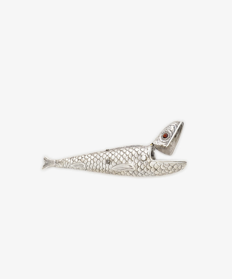 The Vintage Silver Articulating Fish, a detailed fish-shaped charm with movable scales and a partially open mouth, is shown against a plain white background—often considered a lucky talisman.