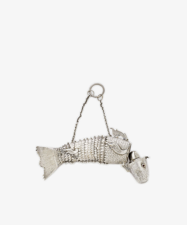 The Vintage Silver Articulating Fish is a charming silver container with a hinged head, decorative scales, and a chain handle on top—an exquisite vintage collectible.