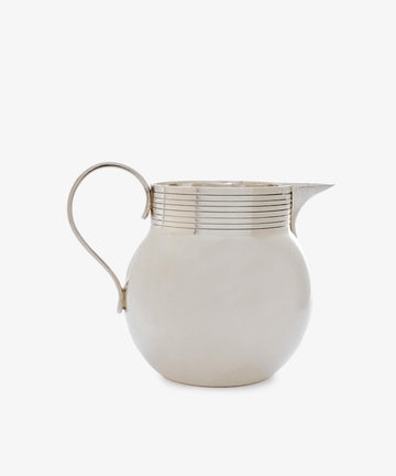 The Vintage Modern English Silver Jug features a polished sculptural form with a rounded body, curved handle, short spout, and horizontal lines near the top—an elegant nod to classic English jug designs.