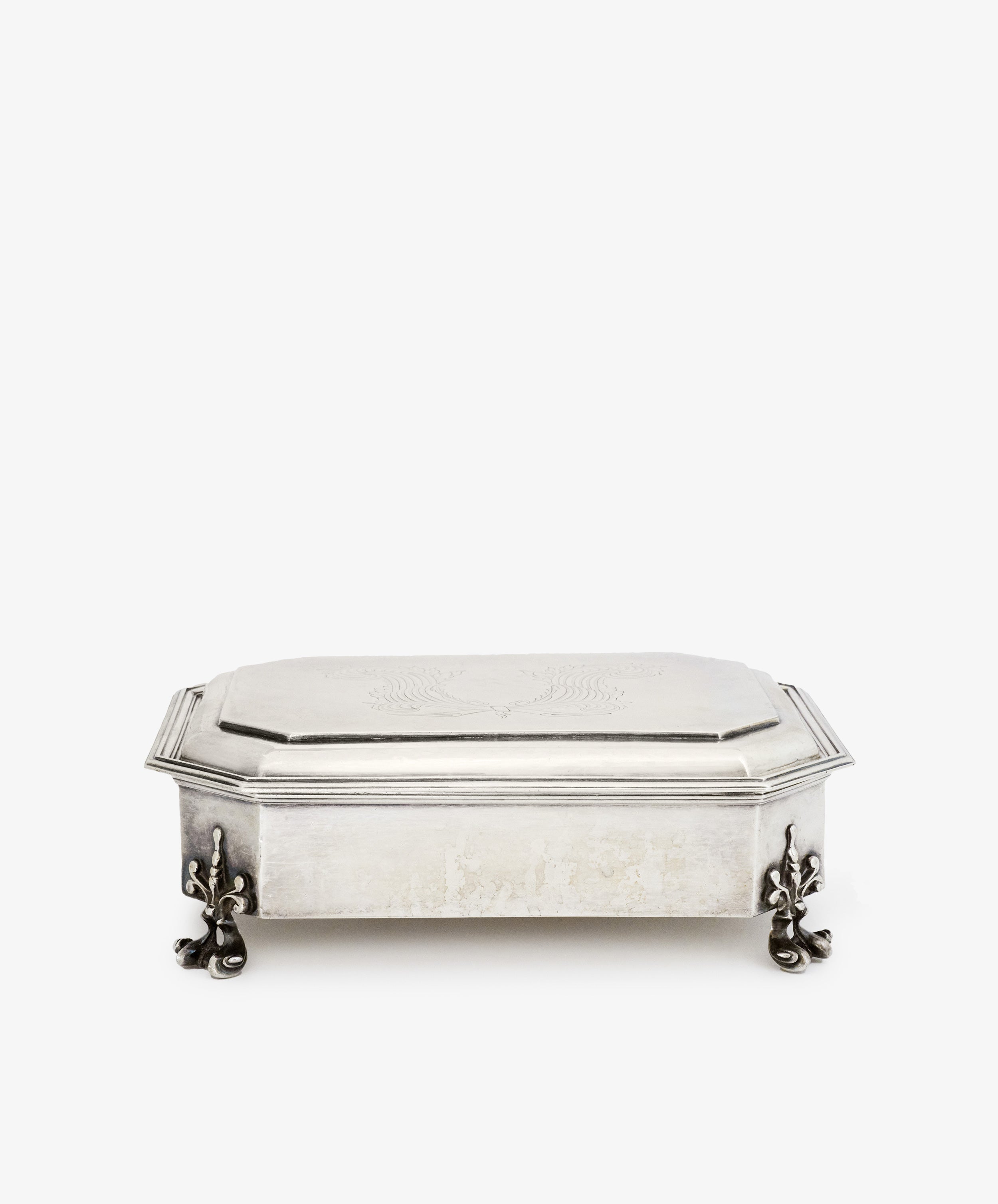 The Vintage English Silver Casket features a rectangular shape, hinged lid, engraved top, and decorative clawed feet in the Charles II style, photographed on a plain white background.