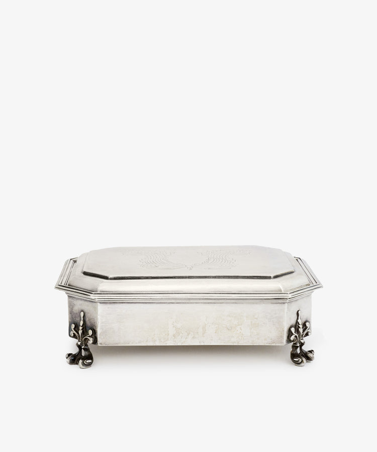 The Vintage English Silver Casket features a rectangular shape, hinged lid, engraved top, and decorative clawed feet in the Charles II style, photographed on a plain white background.