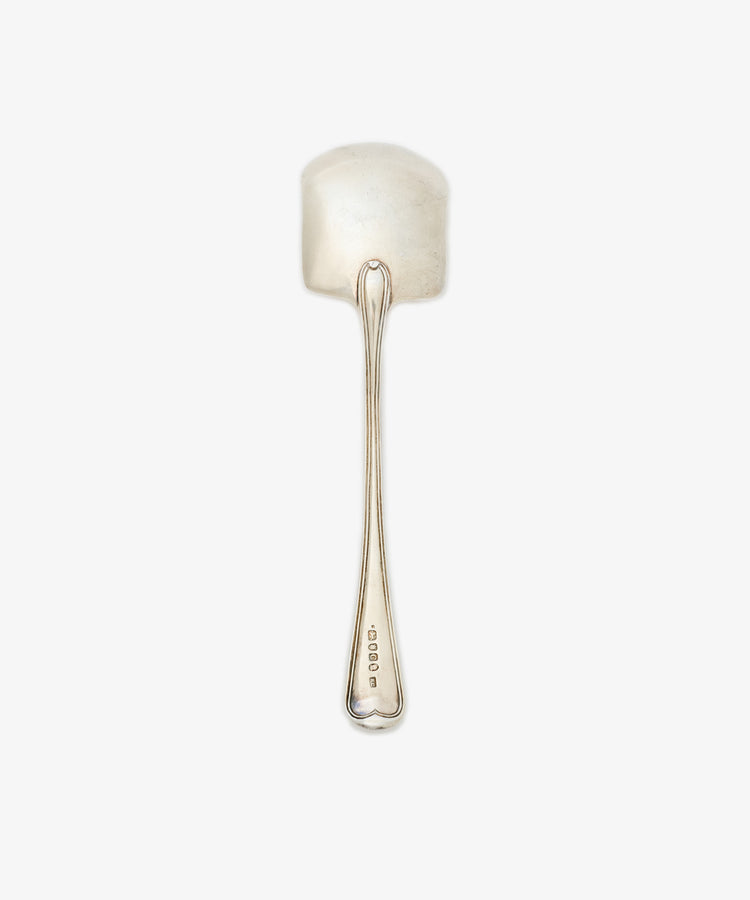 The Vintage English Silver Ice Cream Spade features a wide, flat bowl and long handle, with hallmarks near the base. Crafted in England, this elegant piece is shown on a white background.