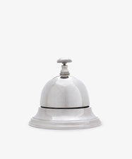 The Vintage English Silver Table Bell features a classic design with a handle, making it a charming addition to any home—perfect as a dinner bell or stylish décor accent.