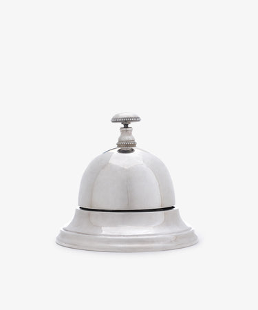 The Vintage English Silver Table Bell features a classic design with a handle, making it a charming addition to any home—perfect as a dinner bell or stylish décor accent.