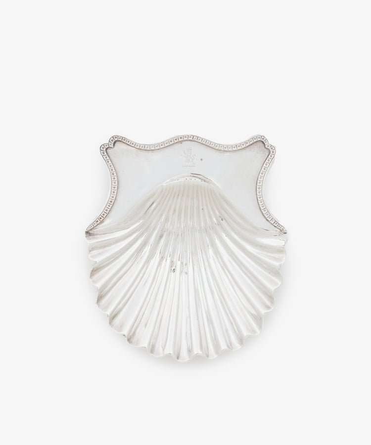 A pair of vintage silver buttershells, each scallop-shaped with an ornate rectangular rim, crafted by renowned Georgian London silversmith Hester Bateman, shown against a plain white background.