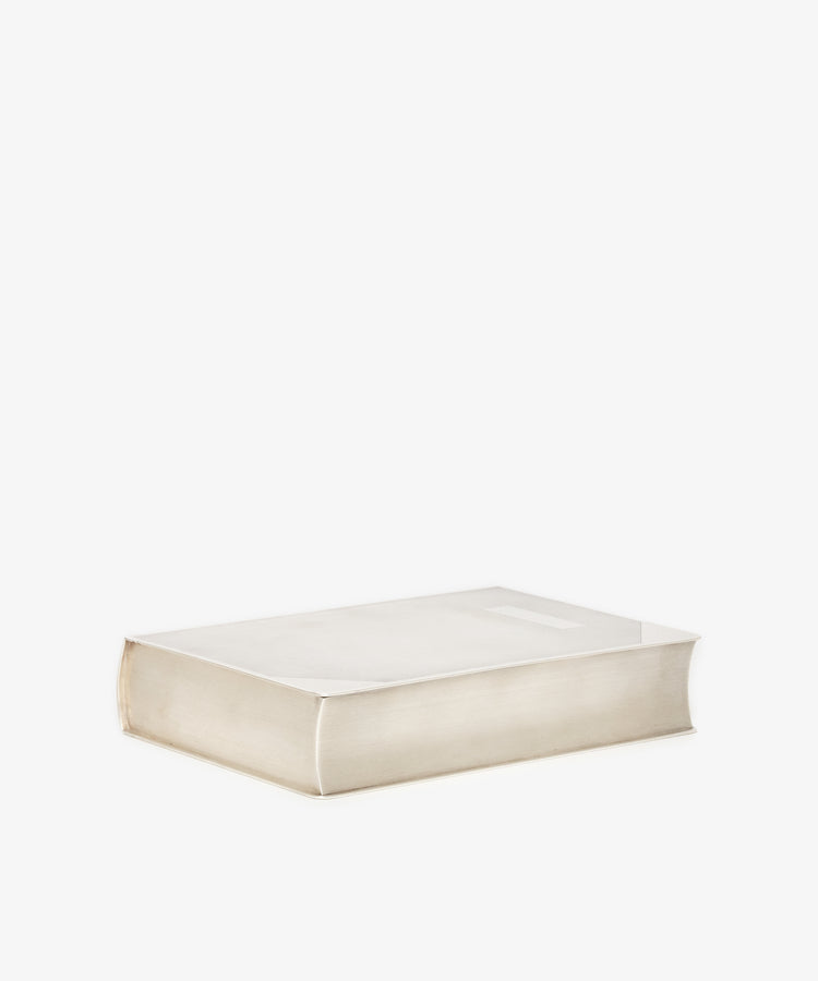 The Vintage Cigarette Box Book, a thick hardcover with a plain white cover, lies flat on a white background, capturing the timeless elegance of a classic collectible.