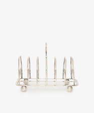 The Vintage George III Toast Rack is beautifully crafted in English silver, featuring six slots and four round feet, displayed on a plain white background.