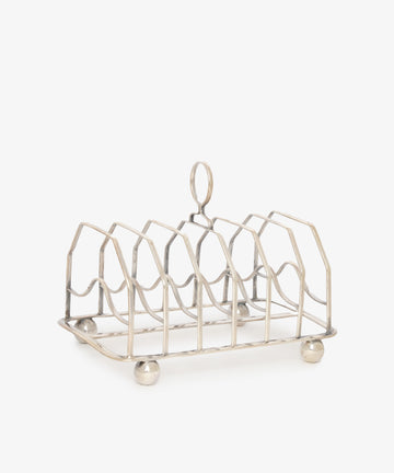 The Vintage George III Toast Rack, crafted from English silver with four slots, a central handle, and four round feet, is set against a plain white background—an ideal piece for any vintage collection.