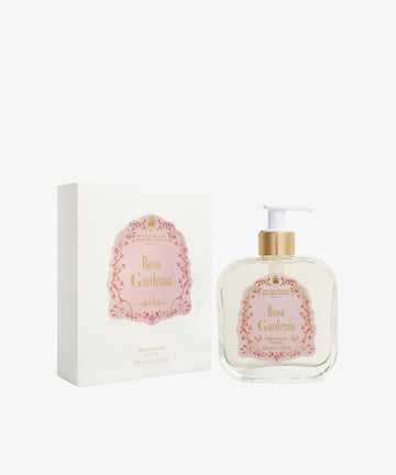 A bottle of Rosa Gardenia Bath Gel with a white pump is displayed beside its coordinating white and pink packaging box.